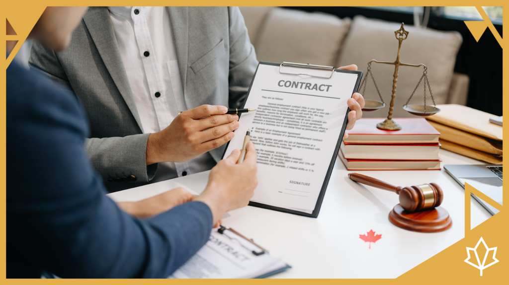 The image is of two people sitting at a desk reviewing an employment contract together, there is a Canadian flag on the desk, a second copy of the contract.